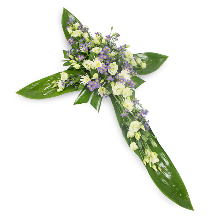 This heartfelt cross carries a measured spirituality through its simple, considered materials-broad, lustrous green leaves sculpt the cross's silhouette, while clusters of pale lisianthus and small white chrysanthemums gather at the centre like a soft chorus of remembrance. The leaves, likely tropical Ti varieties, lend a protective, wing-like quality: their smooth, veined surfaces are a deep, glossy green that frames the softer, cream and ivory tones of the blooms. Interspersed throughout are fine sprays of lavender or light purple asters or limonium, which introduce a cool, contemplative hue and visual depth without upsetting the arrangement's restraint. Delicate stems of smaller green foliage are tucked among the flowers to create gentle movement and a natural, garden-like texture.
Photographed on a stark white background from a slight overhead angle, the cross is illuminated evenly, the light emphasising the difference between the waxy leaves and the feathery petals and giving the whole piece a quiet radiance. The composition is concentrated at the cross's intersection, where the densest floral mass forms a soft, reassuring focal point-an emblem of solace suited to a religious service, graveside ceremony, or memorial held in Garston or along the Mersey banks. The arrangement evokes calm, dignity and continuity, an understated tribute that speaks of hope and enduring affection while honouring traditional expression of faith and mourning.