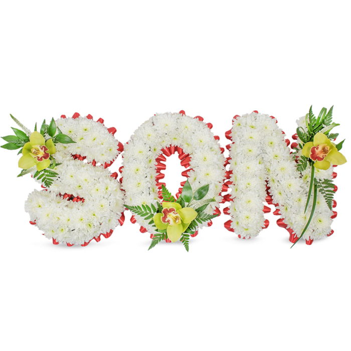 A sculpted sympathy piece spells the name SON in three-dimensional block letters, each built from a profusion of small, immaculate white chrysanthemums that give every letter a full, rounded, and tactile form. The perimeter of each letter is accented with a continuous band of bright red ribbon, folded into neat scallops that create a crisp, visual frame against the soft chrysanthemum surface and introduce a classical warmth to the design. Anchoring the composition are three lime-green Cymbidium orchids - one at the S, one cradled in the base of the O, and a third at the upper stroke of the N - each orchid showing a subtle pale orange to reddish-brown throat that contrasts beautifully with the chartreuse petals. Sprays of rich green foliage and fine fern fronds accompany each orchid, their glossy leaves and feathery textures adding height, movement and natural contrast to the otherwise uniform white field. The arrangement is lit with gentle, diffused illumination that preserves the chrysanthemums' creamy tones while allowing the red ribbon and the orchids' glossy surfaces to register clearly, conveying both dignity and depth. Intended for placement at a funeral service, graveside or memorial chapel, this tribute communicates quiet respect, remembrance and familial love. As a local Garston florist experienced with chapel services and community commemorations, I craft these personalised letter tributes with meticulous attention to proportion, texture and the emotional resonance families ask for in times of loss.