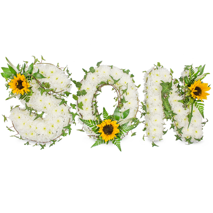 A sculpted three-dimensional tribute spells the word SON in bold capitals, each letter built up from hundreds of tiny white chrysanthemums so tightly packed their surface becomes a soft, tactile field of pale blooms. The chrysanthemums' crisp, ivory faces and overlapping petals form plush contours that read almost like silk under the light. Interwoven through the white mass are trailing strands of dark green ivy with their characteristic lobed leaves and assorted fern fronds and leafy sprigs that add layered colour and a living cadence to the arrangement. Bright sunflowers provide striking points of colour: a large sunflower nestles into the upper-left sweep of the S, a second bold flower fills the lower interior curve of the O amid a halo of fine greenery, and a third bright bloom punctuates the upper-right shoulder of the N - each sunflower's golden petals radiate around a textured, deep brown centre, lifting the overall mood toward hope. The whole composition sits against a stark white backdrop so the contrast between the whites, greens, and yellows reads crisply, and the craftsmanship - the careful placement of foliage and the balanced spacing of blooms - is immediately apparent. Visually, the piece balances solemnity and warmth; emotionally, it speaks of tender remembrance with hints of renewal. It's the kind of bespoke memorial tribute families request for funerals or celebration-of-life services in Garston and surrounding Cressington and Allerton when they want a personalised, heartfelt way to honour a beloved son.