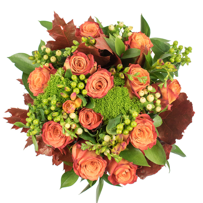 Captured from directly above, this autumn-inspired bouquet is a study in warm colour transitions and tactile layering, designed to read as abundant and composed. The focal point is a generous cluster of large roses, each blossom showing a delicate bicolour: soft, warm orange and peach at the heart, graduating outward to coral and russet-tinged edges that mimic the palette of late-season foliage. Nestled between the roses are clusters of Hypericum berries - vivid lime-green and creamy pale yellow - which act as bright, glossy punctuation marks against the matte petals. The inclusion of Green Trick dianthus introduces dense, moss-like spheres that provide extraordinary texture and visual surprise, their vibrant green softening the arrangement's overall profile. Scattered through the round, tightly packed composition are deep, reddish-brown lobed leaves reminiscent of oak or maple; these elements add autumnal depth and a rustic counterpoint to the blooms. A variety of fresh green leaves, from broad and shiny to more delicate, serrated types, create a layered backdrop that enhances depth and ensures the bouquet reads fully from the top-down view. Light is soft and even, accentuating velvety surfaces and gentle shadows that give the design dimensionality. The scent is subtly earthy with rose overtones, as if gathered from a garden near Garston's green spaces or a stroll by the River Mersey. Thoughtfully arranged for seasonal occasions, this bouquet suits Thanksgiving tables, cosy home décor, or as a considered gift to celebrate harvest, gratitude, and quiet comfort for homes around Allerton, Speke or Garston village.