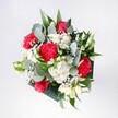 This bouquet appears like a bright Garston morning gathered into your hands, a hand-tied arrangement of crimson roses, pink-red carnations, and snowy white daisies resting in a loose circle of lush greenery. The roses sit proudly at the heart of the design, their velvety petals spiralling inward like quiet promises, while the carnations surround them with ruffled, almost feathery folds that catch the light and deepen the rich reds and pinks. Nestled between them are clusters of tiny, daisy-like chrysanthemums in clean white, their round faces lending an easy, everyday happiness that feels at home on a kitchen table overlooking Garston Park or a sunny windowsill near St Mary's Road. Threaded delicately throughout, fine wisps of baby's breath and gypsophila create a soft, cloudlike layer, lightening the whole arrangement and making the bolder blooms seem to float. Eucalyptus leaves curve out from the centre, bringing cool silver-green tones and a subtle herbal scent that mingles with the sweetness of the roses, while deeper tropical foliage adds glossy, dark green anchors at the base. The bouquet feels carefully composed yet relaxed, as if shaped in calm, natural daylight in the Flowers Garston workshop before heading out for same-day delivery across the neighbourhood. Every stem is placed to create movement without chaos: a graceful dome, full and generous but never crowded. The mood is one of joyful celebration and heartfelt affection, perfect for birthdays, romantic surprises, or simply brightening the hallway of a Garston townhouse with something fresh, fragrant, and undeniably welcoming. Even without seeing it, you can sense the colour, the texture, and the quiet excitement that comes with fresh flowers arriving at the door.