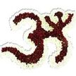 A reverent, sculptural floral tribute shaped as the sacred Om (Aum) symbol sits against a pure white backdrop, its form carved from thousands of tiny, densely packed blooms. The main body of the symbol is composed of rich, dark maroon-to-deep-red chrysanthemum-like flowers, each small pompon revealing a crisp lime-green disk at its centre that gives the mass of crimson a quiet, natural sparkle. A generous, undulating border of pristine white spray chrysanthemums wraps the Om like a glowing halo, defining the curves, loops and interior negative spaces with bright contrast. The tightly clustered petals create a velvety, tactile surface that reads soft yet architecturally precise; a very subtle drop shadow beneath the piece confirms its three-dimensional presence and gives the composition a sense of calm prominence on the white field. In soft studio light the reds feel warm and grounding while the white outline adds a lifted, peaceful radiance.
As a florist who crafts ceremonial pieces for Garston's community gatherings and quiet memorials, I imagine this arrangement carried into a chapel or set before a meditation altar; it speaks of devotion, remembrance and steady contemplation. The scent is understated - an earthy, late-summer chrysanthemum note - and the overall impression is one of care and ritual. Suitable for spiritual events, yoga or remembrance services held in Garston village, at nearby community centres or private homes, the design reads both traditional and contemporary, a hand-made floral emblem that honours heritage while offering visual solace and focus.