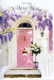A sunlit Garston entryway is transformed into a serene tribute to new chapters and heartfelt welcomes. The focal point is a pale pink front door, gently luminous in the soft light, its pastel colour echoing the tender blush of spring blossoms in local front gardens off Woolton Road. Framing the door, whitewashed walls and a delicately painted shutter catch the brightness of the day, creating a simple, airy backdrop that lets the flowers take centre stage. From above, cascades of lavender wisteria tumble down in loose, romantic clusters, each strand of blossoms forming a natural curtain that softens the edges of the doorway. You can almost imagine the fragrance drifting on the breeze, light and floral, blending with the sound of distant Garston life going by. At the threshold, a vintage-style metal bucket sits proudly, filled to overflowing with creamy white roses. The roses are lush and rounded, their petals layered like folded silk, supported by dusty green foliage that lends depth and a hint of woodland calm. Around the bucket, a soft pink ribbon is tied in a bow, mirroring the door's colour and pulling the composition together with a quiet, stylish touch. Gentle shadows pool at the step, adding dimension without darkening the mood. Everything about the scene feels intimate and optimistic, as though the flowers are there to greet someone who has just collected their keys and is about to cross into their new home for the first time. It is a visual blessing at the doorstep, perfectly suited to celebrate a house move anywhere across Garston and the surrounding Liverpool neighbourhoods.