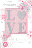 The image shows a beautifully designed anniversary card whose details evoke the care of a hand-tied bouquet arranged somewhere off St Mary's Road or around the heart of Garston. The central element is the word LOVE, standing proud from the surface in raised lettering coated with fine, blush-toned glitter that sparkles subtly rather than loudly. Each letter appears dusted with pearlescent highlights and soft silver accents, giving the impression of petals kissed with morning light. Encircling this word, a series of delicate, flowing floral illustrations crawls across the card. The flowers, leaves, and curling tendrils are drawn in slender lines of pale grey and white, with occasional touches of shimmer that suggest silver ink or foil. The stylized blooms feel almost like an artist's daydream of spring, reminiscent of blossoms you might see in local Garston gardens in early April: light, airy, and full of promise. The soft pink background, gently tinted rather than bold, supports the entire design, creating a hushed, romantic atmosphere. Towards the lower part of the card, a message reading On Our Anniversary and I love you today and always appears in graceful, calligraphic script, its gentle curves echoing the shapes of the leaves and vines. The composition is balanced and refined, with no harsh lines or bright colours, just an overall sense of calm celebration. It feels like holding a quiet, intimate moment in your hands-perfect for a couple in Garston marking another year of shared life and treasured memories together.
